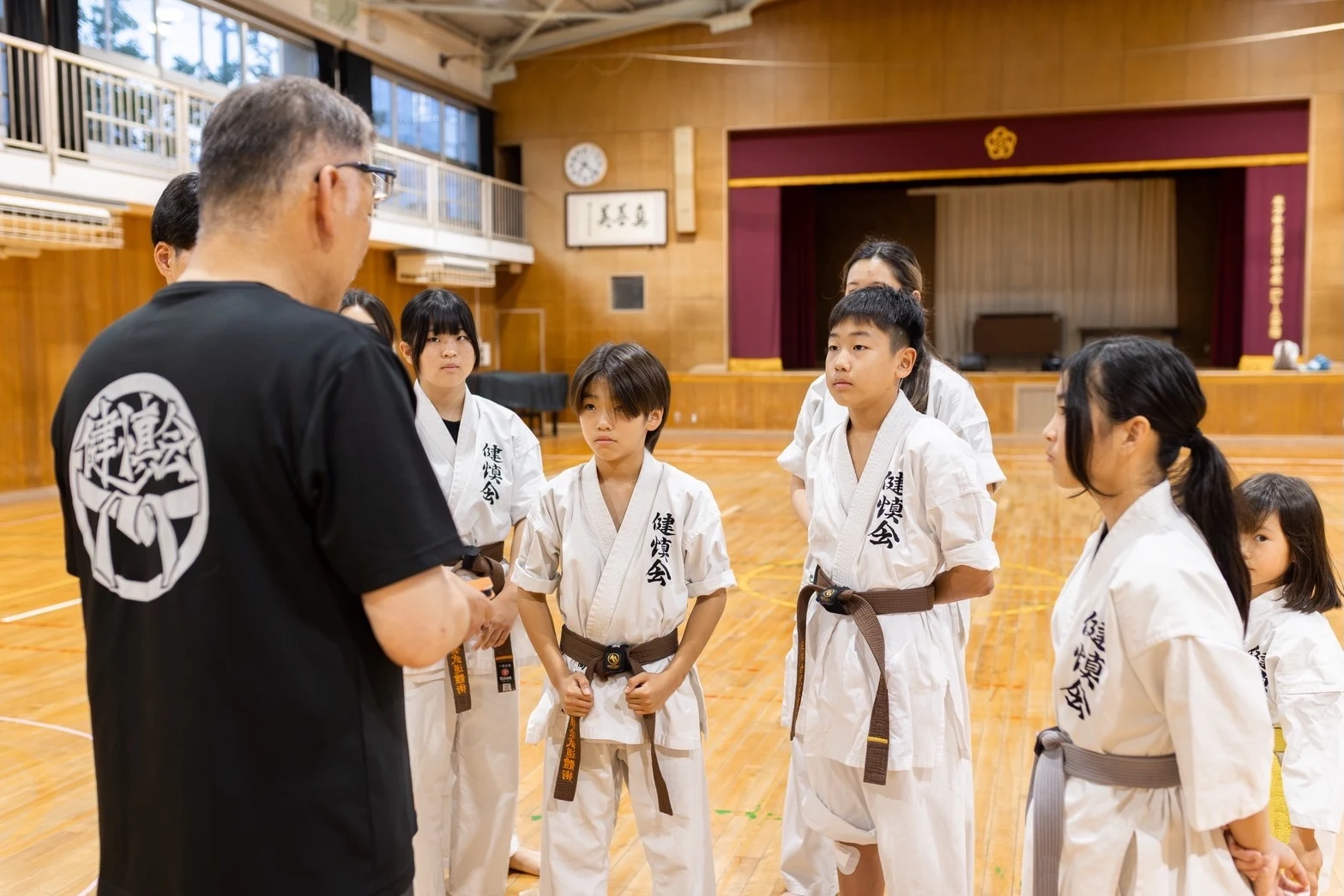 生徒たちに指導する指導員の後ろ姿